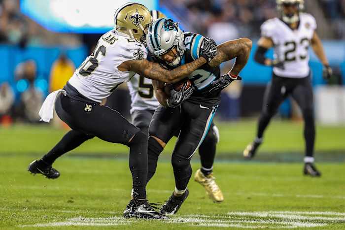 Carolina receiver D.J. Moore (12) is hit after his catch by Saints cornerback P.J. Williams (26). Mandatory Credit: Jim Dedmon-USA TODAY Sports